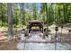 Relax in style with this backyard pergola featuring ample seating and lush wooded views at 2425 Wild Oak Ct, Stockbridge, GA 30281