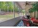 Cozy screened-in porch with comfortable seating and serene views of the wooded backyard at 2425 Wild Oak Ct, Stockbridge, GA 30281
