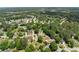 This captivating aerial shot showcases a peaceful neighborhood surrounded by mature trees and green lawns at 2979 Overwood Sw Ln, Snellville, GA 30078