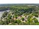 Expansive aerial view of a lakeside community surrounded by lush greenery and mature trees at 2979 Overwood Sw Ln, Snellville, GA 30078