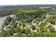 Expansive aerial view of a lakeside community surrounded by lush greenery and mature trees at 2979 Overwood Sw Ln, Snellville, GA 30078