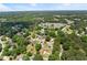 This captivating aerial shot showcases a peaceful neighborhood surrounded by mature trees and green lawns at 2979 Overwood Sw Ln, Snellville, GA 30078