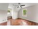 Spacious bedroom featuring a ceiling fan, two bright windows and wood look floors at 2979 Overwood Sw Ln, Snellville, GA 30078