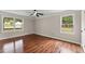 Inviting bedroom with hardwood floors, two large windows, and neutral wall paint at 2979 Overwood Sw Ln, Snellville, GA 30078