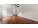 Neutral bedroom with hardwood floors, a ceiling fan, and access to an ensuite bathroom at 2979 Overwood Sw Ln, Snellville, GA 30078