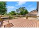 View of the wooden deck with dark railings with a table and chairs on the deck at 2979 Overwood Sw Ln, Snellville, GA 30078