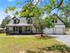 Charming two-story home with a welcoming front porch and a convenient two-car garage at 2979 Overwood Sw Ln, Snellville, GA 30078