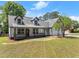 Attractive two-story house featuring a covered porch and a double garage, set on a well-maintained lawn at 2979 Overwood Sw Ln, Snellville, GA 30078