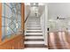 Inviting home entry showcasing a staircase, decorative door, and views into a spacious living area with hardwood floors at 2979 Overwood Sw Ln, Snellville, GA 30078