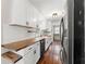 Stylish kitchen with white cabinets, butcher block countertops, and stainless steel appliances at 2979 Overwood Sw Ln, Snellville, GA 30078