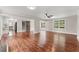 Spacious living room with hardwood floors, large windows, and a decorative barn door leading to the staircase at 2979 Overwood Sw Ln, Snellville, GA 30078