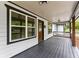 View of the charming covered front porch, showcasing the home's inviting entryway and cozy outdoor space at 2979 Overwood Sw Ln, Snellville, GA 30078
