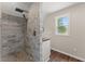 Modern shower with marble look tile and wooden style floors at 2979 Overwood Sw Ln, Snellville, GA 30078