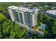 Aerial view of the condominium building with lush greenery and a sparkling swimming pool at 3300 Windy Ridge Se Pkwy # 1401, Atlanta, GA 30339