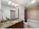 Bathroom showcasing a granite vanity, updated fixtures, and a shower-tub combo with tile surround at 3300 Windy Ridge Se Pkwy # 1401, Atlanta, GA 30339