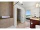 Bathroom featuring a tiled shower, granite vanity, and a door leading to bedroom at 3300 Windy Ridge Se Pkwy # 1401, Atlanta, GA 30339