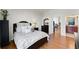 Cozy bedroom featuring neutral decor, hardwood floors, and a glimpse into the living room and bathroom at 3300 Windy Ridge Se Pkwy # 1401, Atlanta, GA 30339