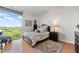 Comfortable bedroom featuring a large window with scenic views and stylish decor at 3300 Windy Ridge Se Pkwy # 1401, Atlanta, GA 30339