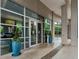 Elegant building entrance with modern glass doors, manicured planters, and stone accents at 3300 Windy Ridge Se Pkwy # 1401, Atlanta, GA 30339