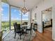Elegant dining area with hardwood floors, modern chandelier, and access to the main bedroom at 3300 Windy Ridge Se Pkwy # 1401, Atlanta, GA 30339