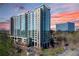 Contemporary high-rise building with glass facade, multiple balconies, and well maintained landscaping at 3300 Windy Ridge Se Pkwy # 1401, Atlanta, GA 30339