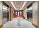Hallway featuring elevators, wood accents, and modern lighting fixtures at 3300 Windy Ridge Se Pkwy # 1401, Atlanta, GA 30339