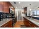 Kitchen featuring dark cabinets, granite countertops, stainless steel appliances, and black backsplash at 3300 Windy Ridge Se Pkwy # 1401, Atlanta, GA 30339
