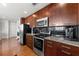 Kitchen featuring dark wood cabinets, granite countertops, and stainless steel appliances at 3300 Windy Ridge Se Pkwy # 1401, Atlanta, GA 30339