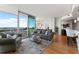 Spacious living area with hardwood floors, comfortable seating, sliding door to balcony, and open kitchen at 3300 Windy Ridge Se Pkwy # 1401, Atlanta, GA 30339