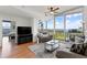Comfortable living room with hardwood floors, large windows with balcony access, and a stylish seating area at 3300 Windy Ridge Se Pkwy # 1401, Atlanta, GA 30339