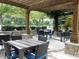 Charming outdoor dining area with pergola, stone pillars, and seating for entertaining guests at 3300 Windy Ridge Se Pkwy # 1401, Atlanta, GA 30339