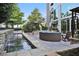 Relaxing outdoor patio area with a water feature, stone accents, and comfortable seating at 3300 Windy Ridge Se Pkwy # 1401, Atlanta, GA 30339