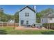 View of the home's rear exterior, wooden deck, hot tub, string lights, and fenced yard at 632 Warren Ave, Scottdale, GA 30079