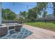 Backyard with outdoor seating, hot tub, wood deck, string lights, and grassy lawn at 632 Warren Ave, Scottdale, GA 30079