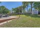 Large, grassy backyard featuring a wooden deck, string lights, and privacy fence at 632 Warren Ave, Scottdale, GA 30079