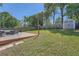 Spacious backyard featuring a wooden deck and a storage shed with a fenced perimeter and mature trees at 632 Warren Ave, Scottdale, GA 30079