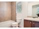 Bathroom with tiled walls, vanity, and a combination bathtub and shower with a window at 632 Warren Ave, Scottdale, GA 30079