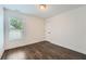 Cozy bedroom with dark wood floors, white walls and trim, and large bright window at 632 Warren Ave, Scottdale, GA 30079