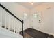 Entryway featuring light walls, dark wood floors, and a paneled front door at 632 Warren Ave, Scottdale, GA 30079