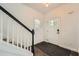 Inviting entryway boasts stylish black staircase and pristine white front door at 632 Warren Ave, Scottdale, GA 30079