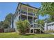 Two-story home boasts dual porches, blue siding, and a lush front lawn at 632 Warren Ave, Scottdale, GA 30079