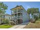 Two-story home with a blue exterior, white columns, and a driveway at 632 Warren Ave, Scottdale, GA 30079
