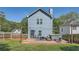 Back exterior view of a light blue two-story house featuring a deck with furniture, a hot tub, and a fenced backyard at 632 Warren Ave, Scottdale, GA 30079