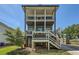 Two-story home with dual porches, light blue siding, and a quaint yard at 632 Warren Ave, Scottdale, GA 30079