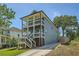 Two-story home boasting dual porches, blue siding, and a private driveway at 632 Warren Ave, Scottdale, GA 30079
