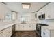 Updated kitchen boasts white cabinets, quartz countertops, stainless steel appliances, and tile backsplash at 632 Warren Ave, Scottdale, GA 30079