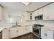 Bright kitchen with white cabinets, stainless appliances, and plenty of counter space at 632 Warren Ave, Scottdale, GA 30079