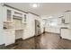 Bright kitchen featuring white cabinets, stainless steel appliances, and herringbone wood floors at 632 Warren Ave, Scottdale, GA 30079