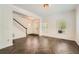 Bright living room with wood floors, light-colored walls and staircase at 632 Warren Ave, Scottdale, GA 30079