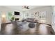 Sunlit living room boasts a fireplace, herringbone floors, and modern decor with neutral tones at 632 Warren Ave, Scottdale, GA 30079